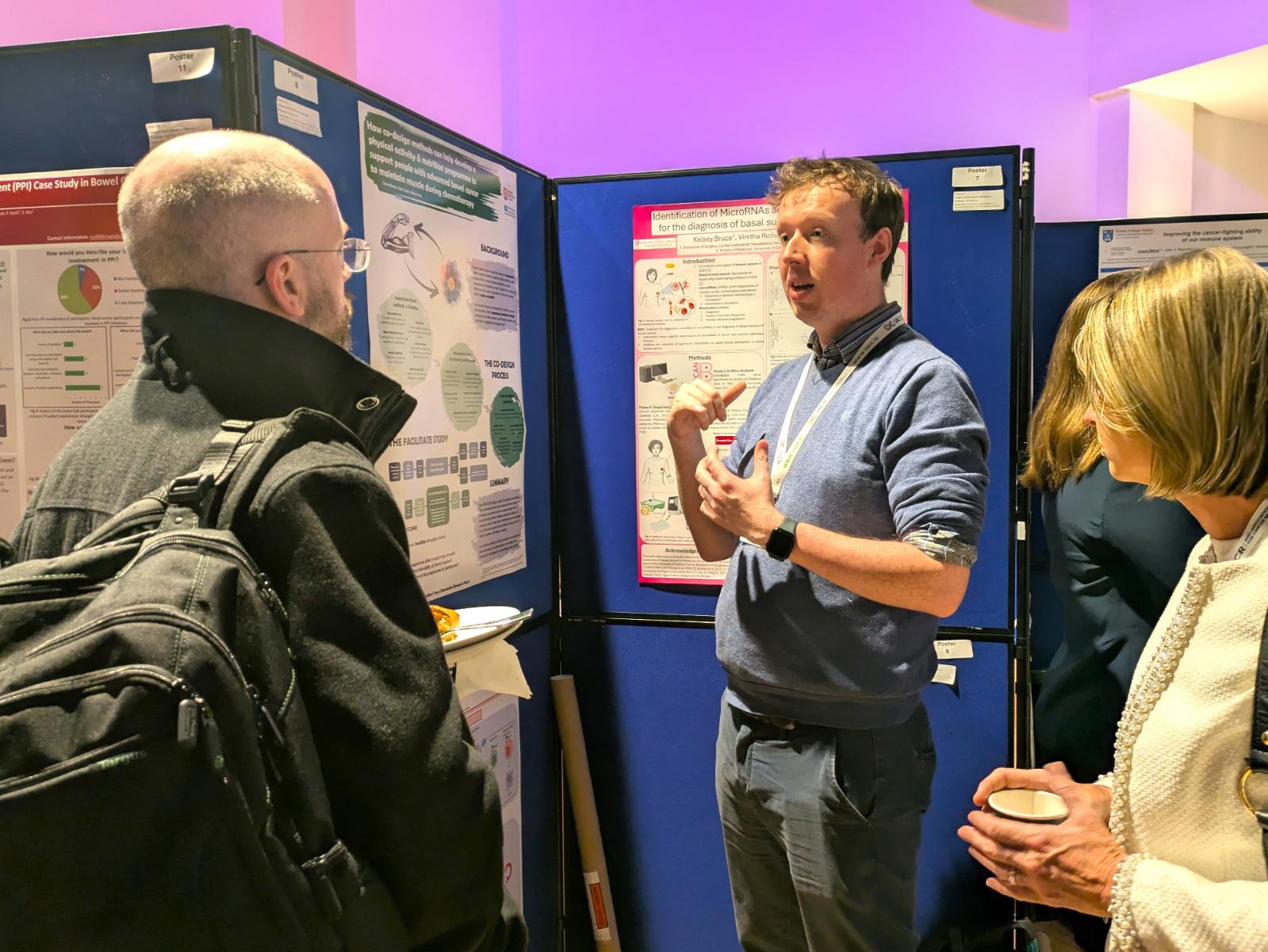 Dr Burke explains his poster to members of the public